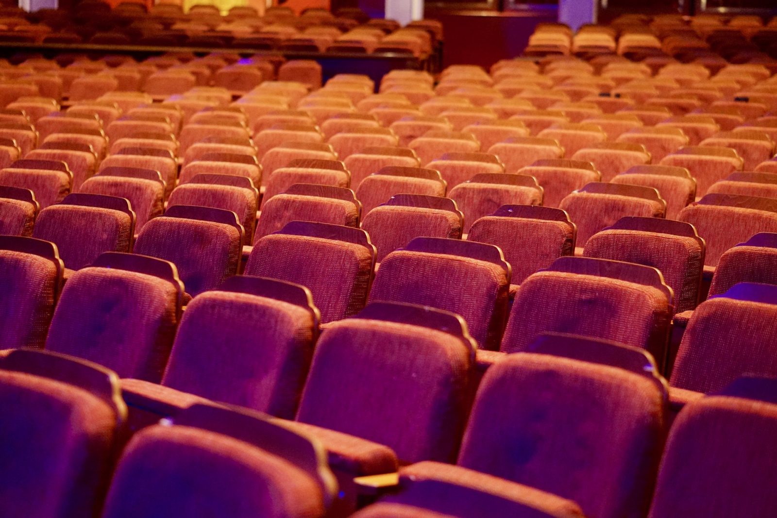 Rows of red velvet theatre seats
